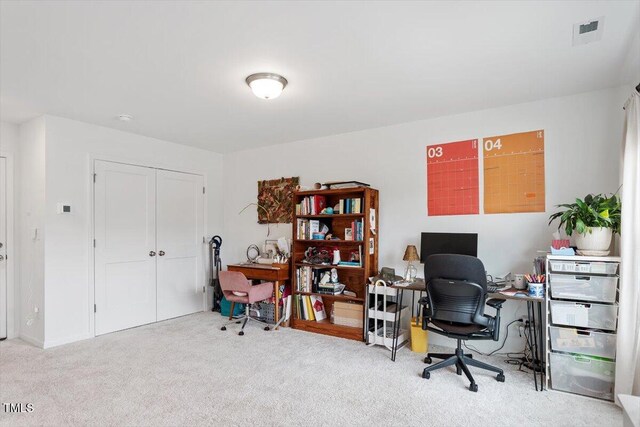carpeted home office featuring visible vents