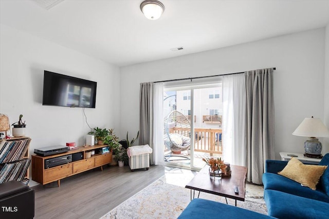 living room featuring wood finished floors and visible vents