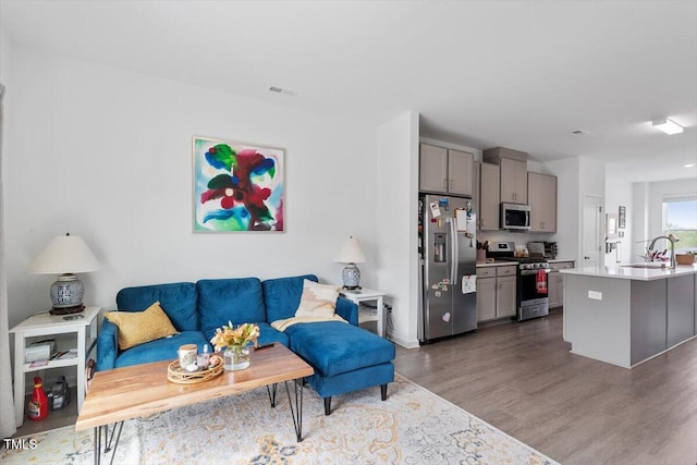 living room featuring visible vents and dark wood-style floors