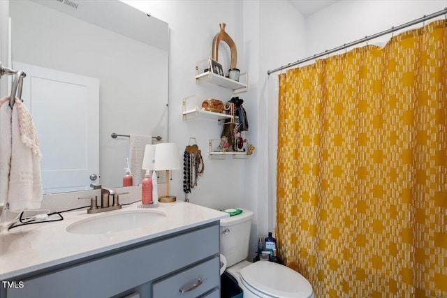 bathroom featuring toilet, a shower with curtain, and vanity