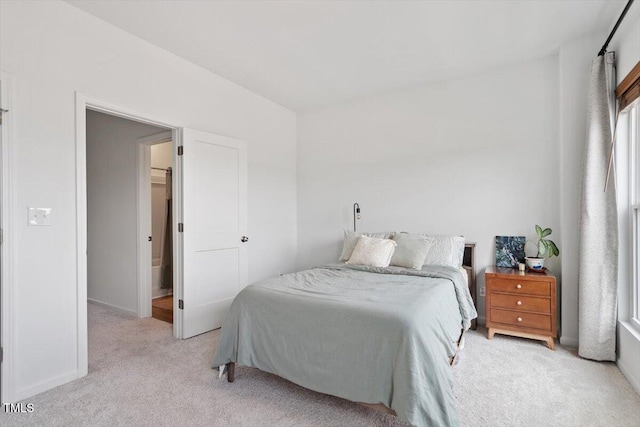 bedroom with baseboards and carpet