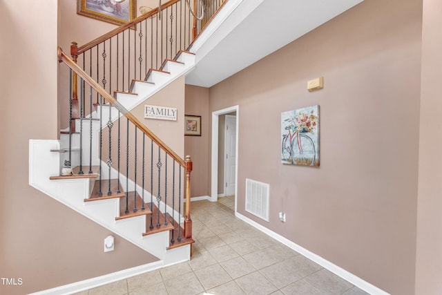 9332 Leslieshire Dr, Raleigh, NC 27615 - stairs featuring visible vents, tile patterned floors, and baseboards