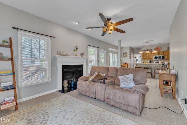 9332 Leslieshire Dr, Raleigh, NC 27615 - living room with a fireplace with flush hearth, light tile patterned floors, baseboards, and a ceiling fan