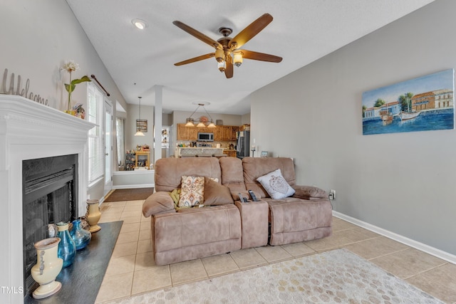 9332 Leslieshire Dr, Raleigh, NC 27615 - living room with light tile patterned floors, baseboards, a ceiling fan, and a fireplace with raised hearth