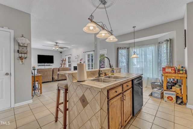 9332 Leslieshire Dr, Raleigh, NC 27615 - kitchen featuring a sink, a ceiling fan, light tile patterned flooring, and dishwashing machine