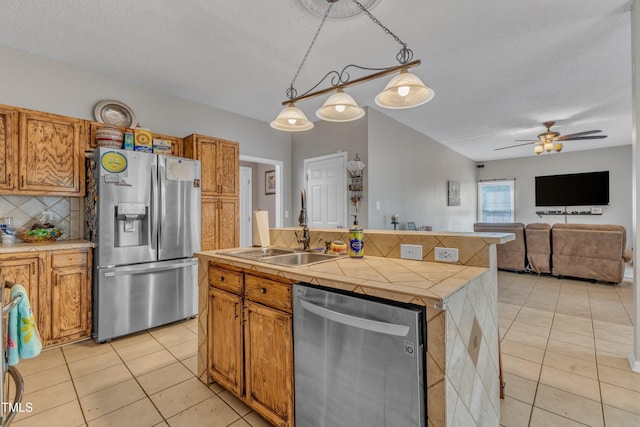 9332 Leslieshire Dr, Raleigh, NC 27615 - kitchen with tasteful backsplash, light tile patterned floors, a sink, and appliances with stainless steel finishes
