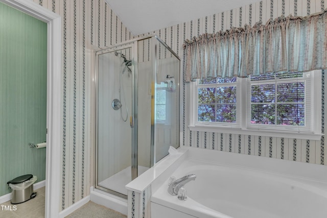 9332 Leslieshire Dr, Raleigh, NC 27615 - full bathroom featuring a shower stall, wallpapered walls, baseboards, and a garden tub