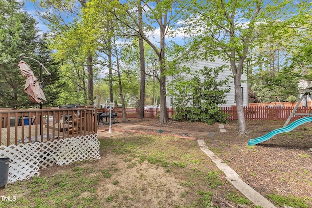 9332 Leslieshire Dr, Raleigh, NC 27615 - view of yard with fence, a deck, and a playground