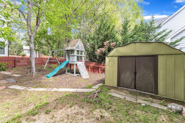 9332 Leslieshire Dr, Raleigh, NC 27615 - view of playground featuring a fenced backyard, an outdoor structure, and a storage unit