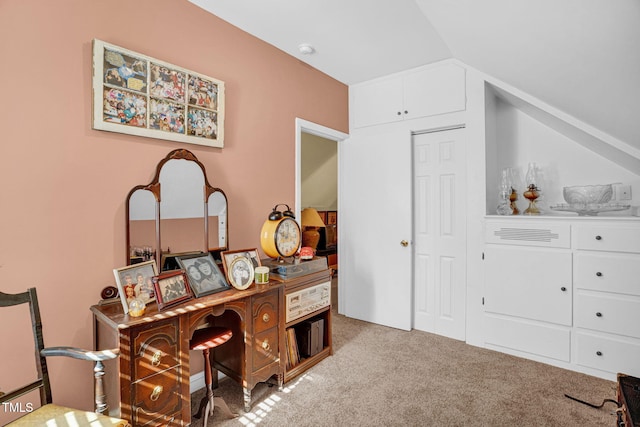 home office featuring carpet and lofted ceiling