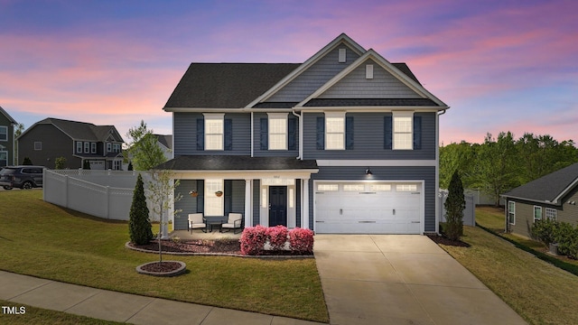 view of front of home with an attached garage, concrete driveway, and covered porch