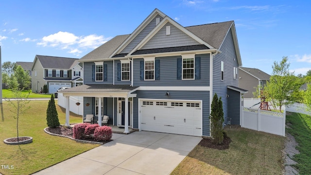 traditional home with a porch, driveway, and an attached garage