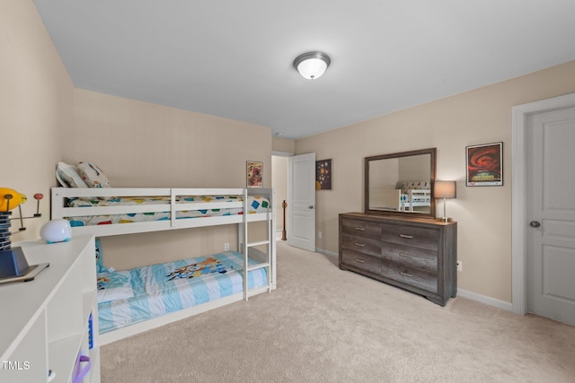 carpeted bedroom featuring baseboards