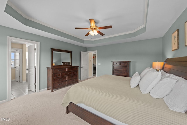 bedroom featuring a raised ceiling, baseboards, light carpet, crown molding, and ceiling fan