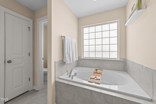 full bath with a bath, toilet, and tile patterned flooring