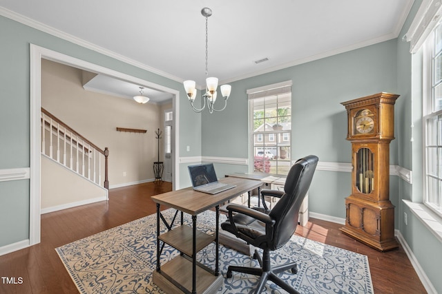 office space with wood finished floors, ornamental molding, a chandelier, and baseboards