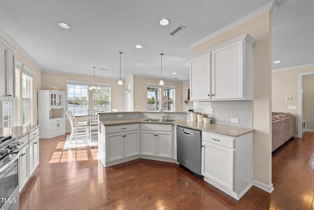 kitchen featuring appliances with stainless steel finishes, a sink, a peninsula, white cabinetry, and recessed lighting