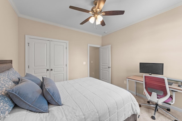 carpeted bedroom featuring crown molding, a closet, a ceiling fan, a desk, and baseboards