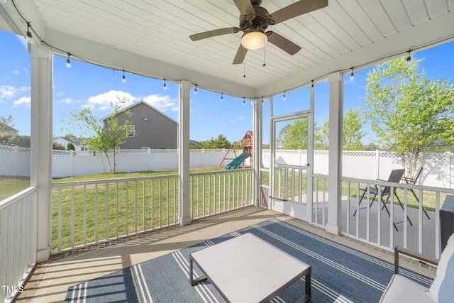 unfurnished sunroom featuring a ceiling fan