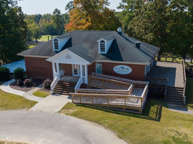 140 Clear Water Rd, Louisburg, NC 27549 - view of front facade with a deck, stairway, brick siding, french doors, and a front lawn