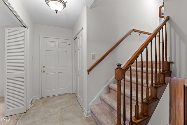 entryway with stairs and baseboards