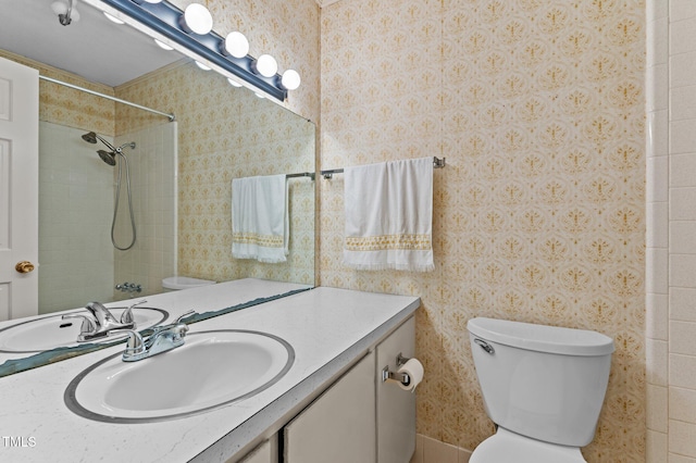 full bath with walk in shower, vanity, wallpapered walls, and toilet