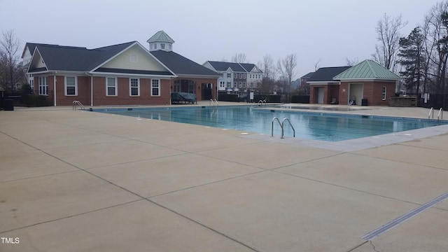community pool with a patio area