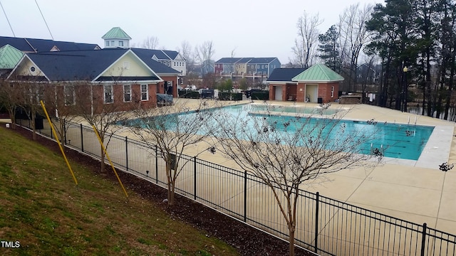 community pool featuring fence and a patio