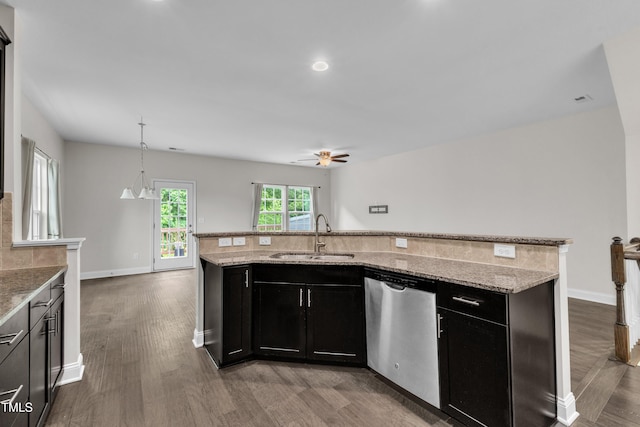 kitchen featuring a sink, stainless steel dishwasher, wood finished floors, dark cabinetry, and ceiling fan