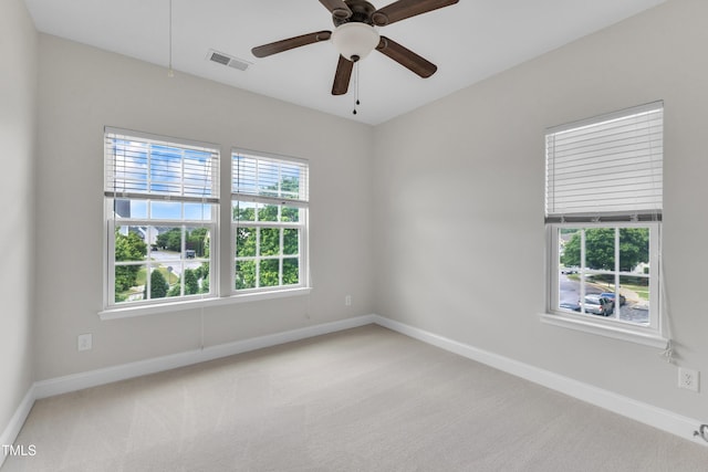 unfurnished room with baseboards, carpet flooring, and a ceiling fan