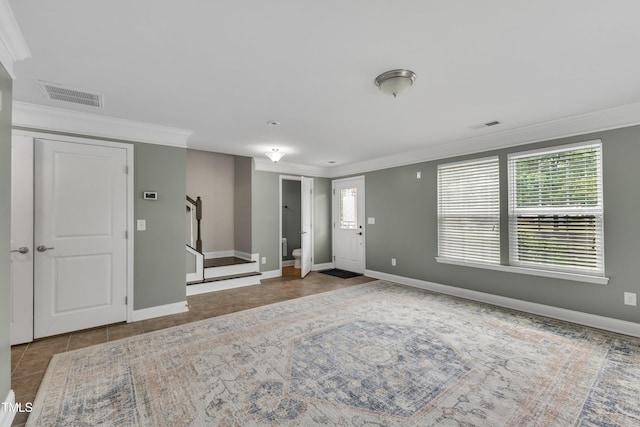 foyer with crown molding, stairway, baseboards, and tile patterned flooring