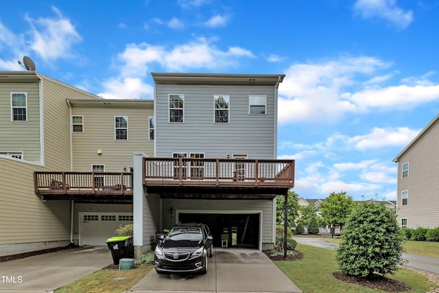 back of house featuring driveway and an attached garage