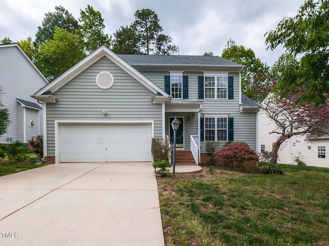 traditional home featuring an attached garage, driveway, and a front yard