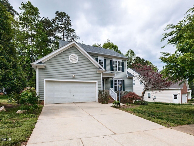 view of front facade featuring a front yard and concrete driveway