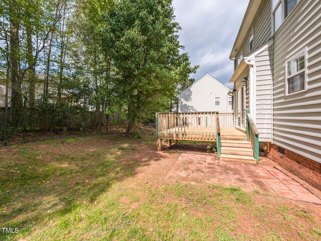 view of yard featuring fence and a wooden deck