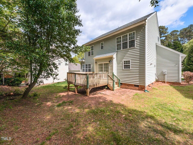 rear view of house with a yard, crawl space, and a deck