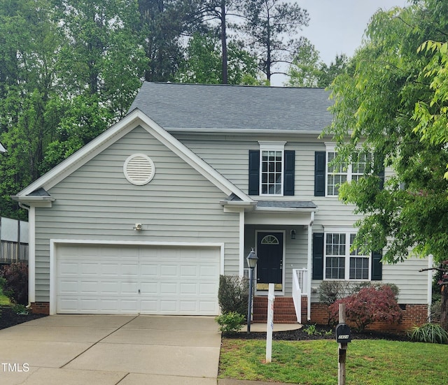 view of front of house featuring driveway, roof with shingles, and a garage
