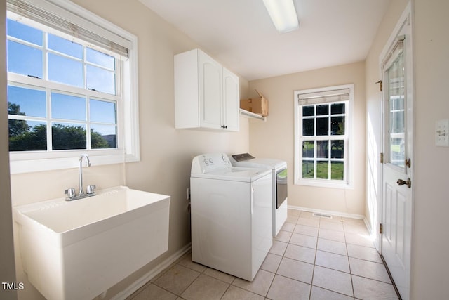 78 Cross Creek Ct, Timberlake, NC 27583 - clothes washing area featuring washing machine and dryer, baseboards, cabinet space, and light tile patterned flooring