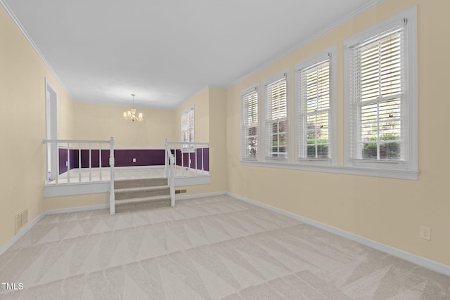 1304 Deboy St, Raleigh, NC 27606 - spare room featuring a wealth of natural light, a notable chandelier, ornamental molding, and carpet floors