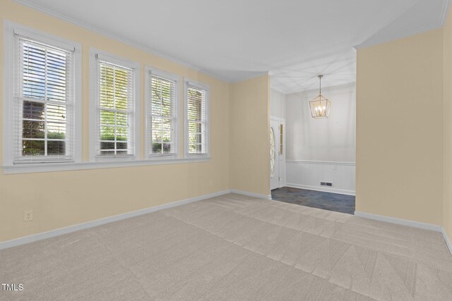 1304 Deboy St, Raleigh, NC 27606 - carpeted spare room featuring an inviting chandelier, baseboards, ornamental molding, and visible vents
