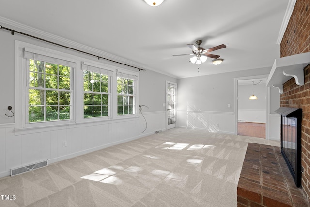 1304 Deboy St, Raleigh, NC 27606 - unfurnished living room featuring visible vents, a ceiling fan, wainscoting, and a brick fireplace