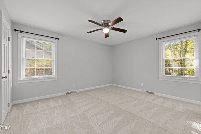 1304 Deboy St, Raleigh, NC 27606 - empty room featuring visible vents, light colored carpet, baseboards, and ceiling fan