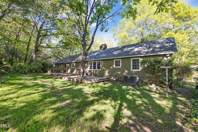 1304 Deboy St, Raleigh, NC 27606 - back of property with a yard, a chimney, a deck, and central air condition unit