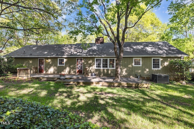 1304 Deboy St, Raleigh, NC 27606 - rear view of property with cooling unit, a chimney, a wooden deck, and a lawn