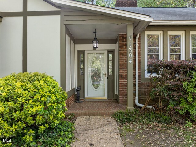 1304 Deboy St, Raleigh, NC 27606 - property entrance featuring brick siding and a chimney