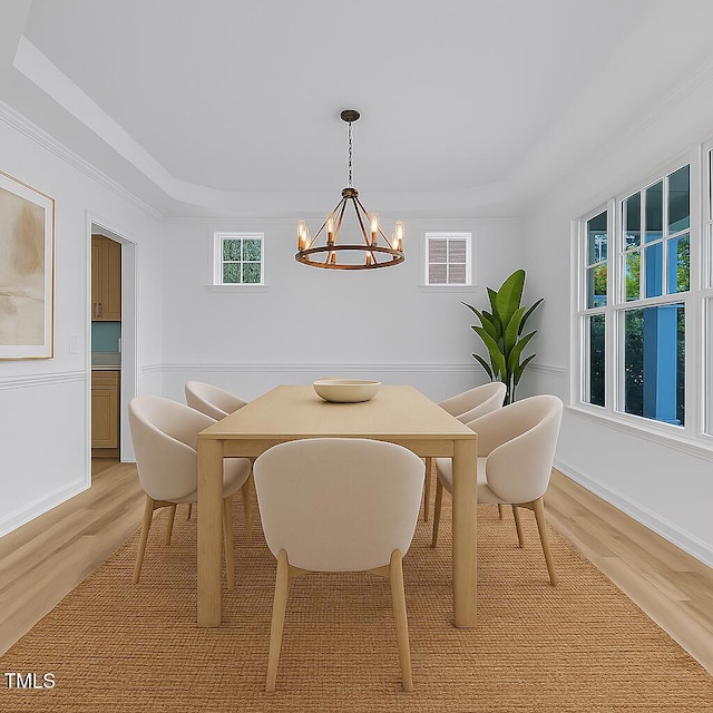 858 Lake Artesia Ln, Fuquay Varina, NC 27526 - dining room with light wood-style floors, a chandelier, a tray ceiling, ornamental molding, and baseboards