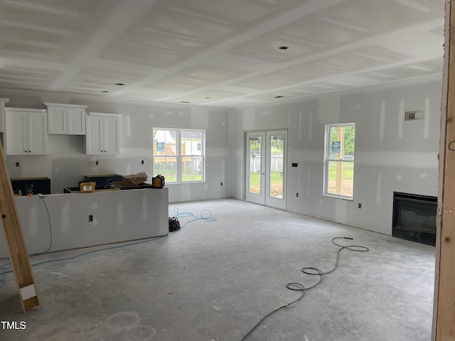 unfurnished living room featuring unfinished concrete flooring and a fireplace