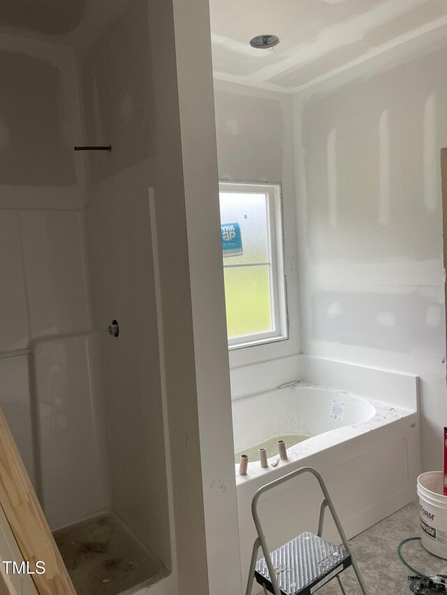 full bath with a bath and a shower