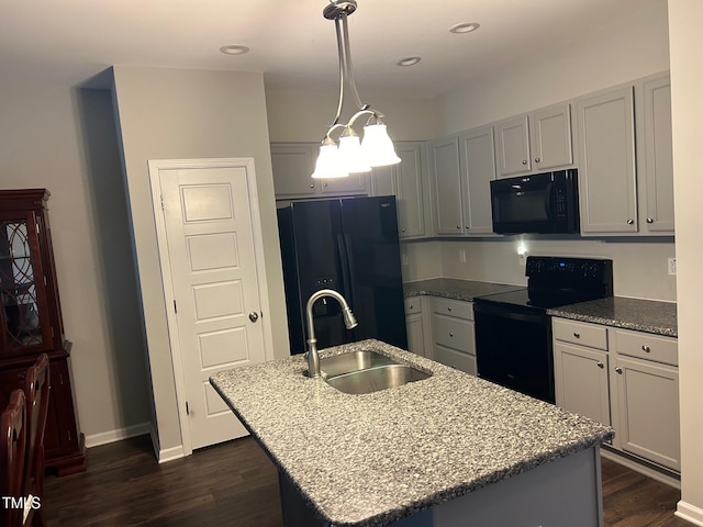 48 Cullen Ct, Clayton, NC 27520 - kitchen with black appliances, light stone counters, a sink, a center island with sink, and dark wood-style floors