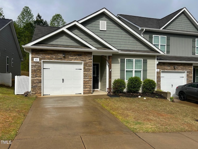 48 Cullen Ct, Clayton, NC 27520 - craftsman house with a garage, driveway, stone siding, and a front lawn